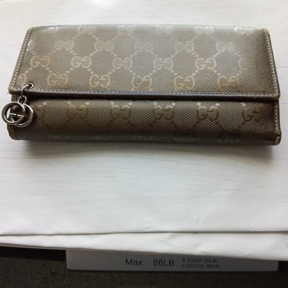 Authentic Gucci Metallic brown Signature wallet with GG charm - Picture 1 of 16